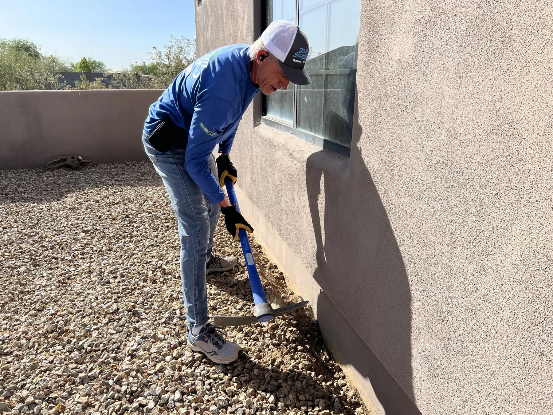 Treating the stem wall and landscape rock around the perimeter of an Arizona home